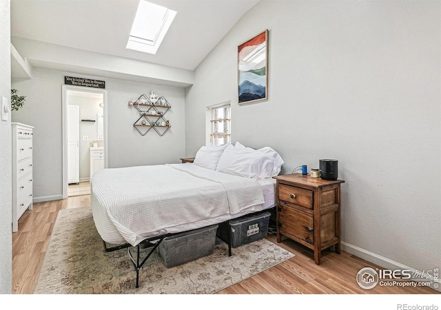 1970 Willow St, Denver, CO 80220 - bedroom with a skylight, light wood finished floors, lofted ceiling, baseboards, and ensuite bath