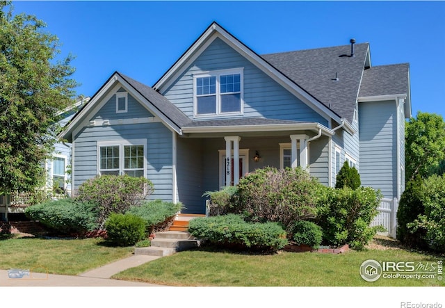 4218 San Marco Dr, Longmont, CO 80503 - bungalow-style house with a porch, a front yard, and roof with shingles