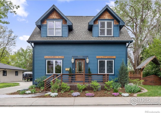 view of front of home featuring roof with shingles and covered porch
