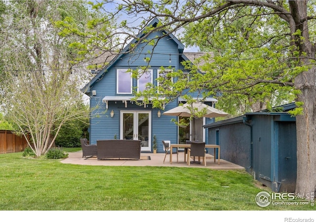 back of property with a patio area, french doors, and an outdoor living space