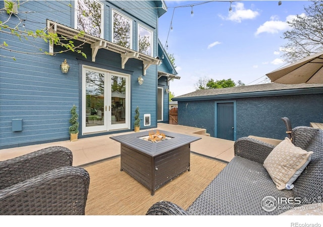 wooden terrace with french doors and an outdoor fire pit