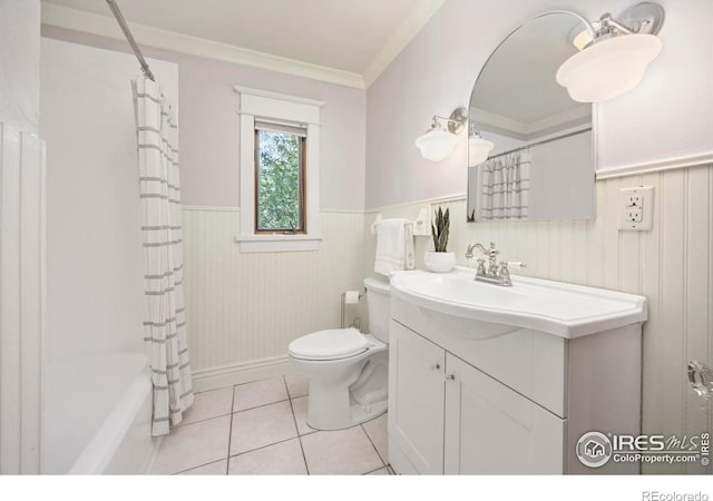 full bathroom featuring wainscoting, toilet, ornamental molding, vanity, and tile patterned flooring
