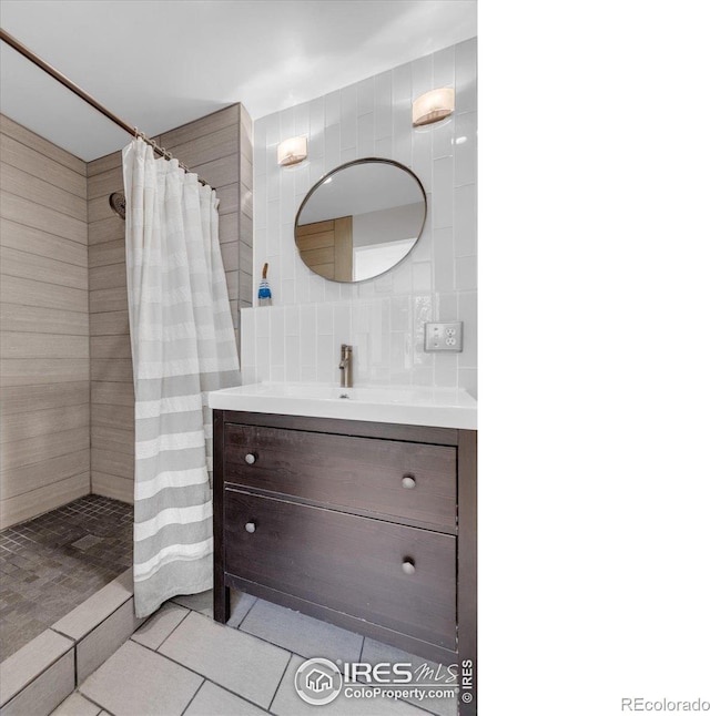 3582 Smuggler Way, Boulder, CO 80305 - full bath with vanity, a tile shower, tile walls, and tile patterned floors