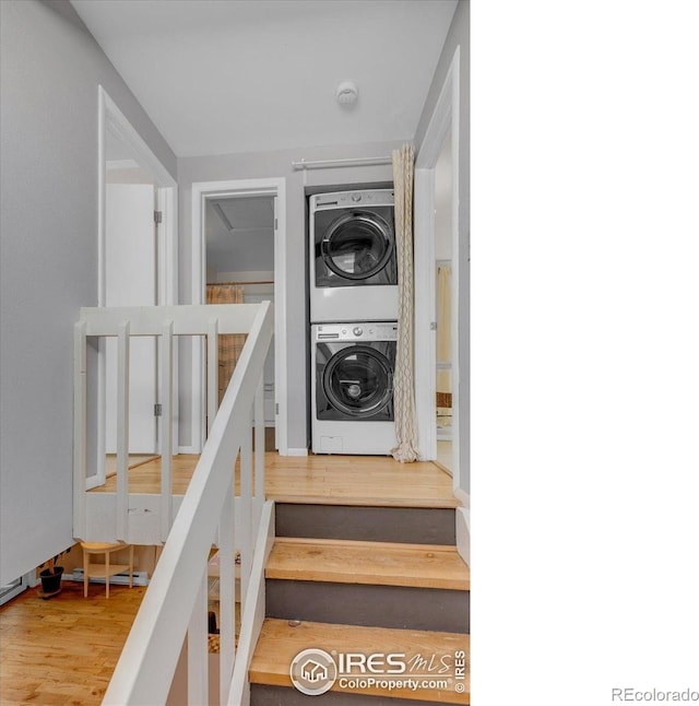 3582 Smuggler Way, Boulder, CO 80305 - stairs featuring stacked washer and clothes dryer and wood finished floors