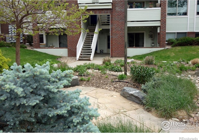 33 S Boulder Cir Unit 122, Boulder, CO 80303 - back of property featuring stairway, a patio, and brick siding