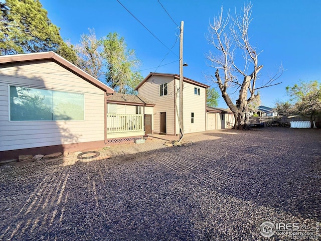rear view of property featuring fence