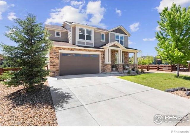 craftsman inspired home with concrete driveway, an attached garage, and stone siding