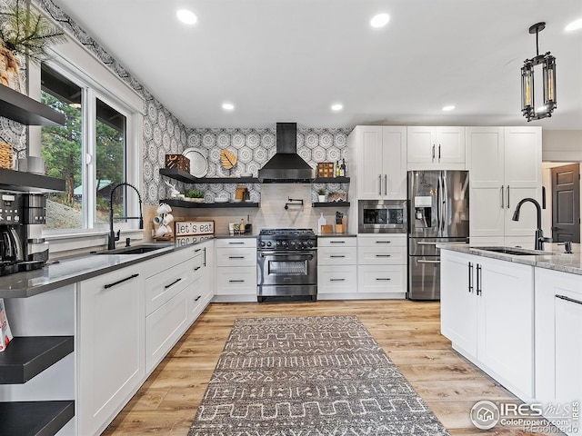 370 Big Boulder Dr, Estes Park, CO 80517 - kitchen with open shelves, stainless steel appliances, wall chimney exhaust hood, a sink, and recessed lighting