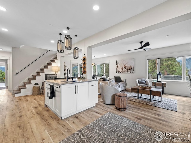 370 Big Boulder Dr, Estes Park, CO 80517 - kitchen with open floor plan, light wood-style flooring, recessed lighting, white cabinets, and healthy amount of natural light