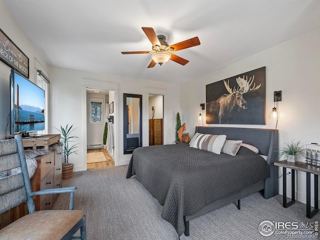 370 Big Boulder Dr, Estes Park, CO 80517 - carpeted bedroom with a baseboard heating unit, ensuite bath, a ceiling fan, and baseboards