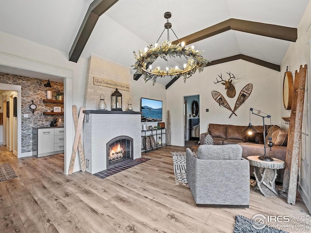 370 Big Boulder Dr, Estes Park, CO 80517 - living area featuring beamed ceiling, a chandelier, light wood-style floors, a fireplace, and high vaulted ceiling