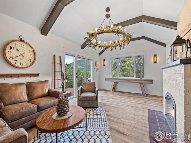 370 Big Boulder Dr, Estes Park, CO 80517 - living area featuring a fireplace, a chandelier, wood finished floors, and baseboards