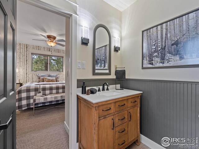 370 Big Boulder Dr, Estes Park, CO 80517 - bathroom featuring a ceiling fan, wainscoting, and vanity