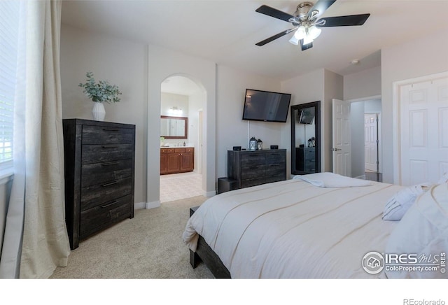 489 Hayloft Way, Brighton, CO 80601 - carpeted bedroom with arched walkways, ensuite bath, ceiling fan, and baseboards