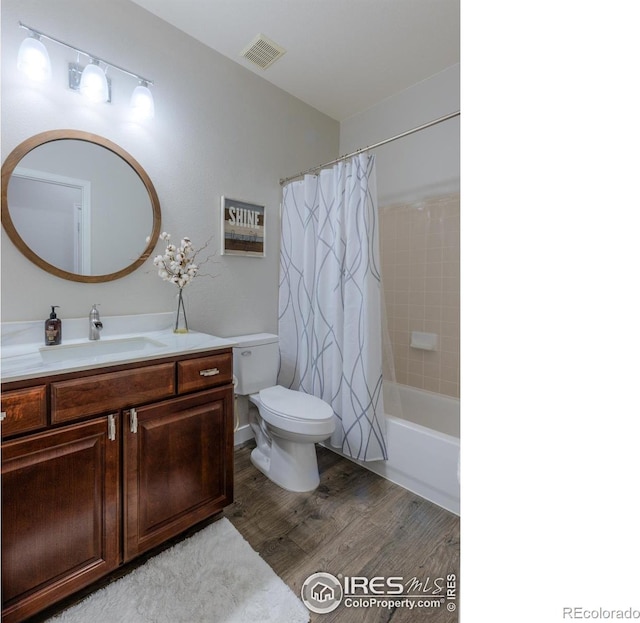 489 Hayloft Way, Brighton, CO 80601 - bathroom with toilet, wood finished floors, vanity, and shower / bath combo with shower curtain
