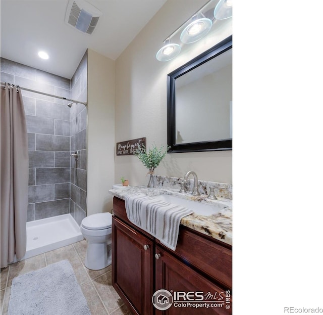 489 Hayloft Way, Brighton, CO 80601 - bathroom with toilet, a tile shower, vanity, and tile patterned floors