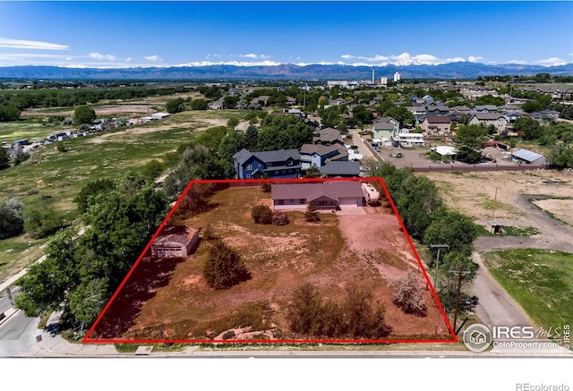 10007 E County Line Rd, Longmont, CO 80501 - aerial perspective of suburban area with mountains and property parcel outlined