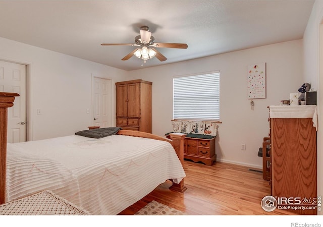 10007 E County Line Rd, Longmont, CO 80501 - bedroom with light wood finished floors, a ceiling fan, and baseboards
