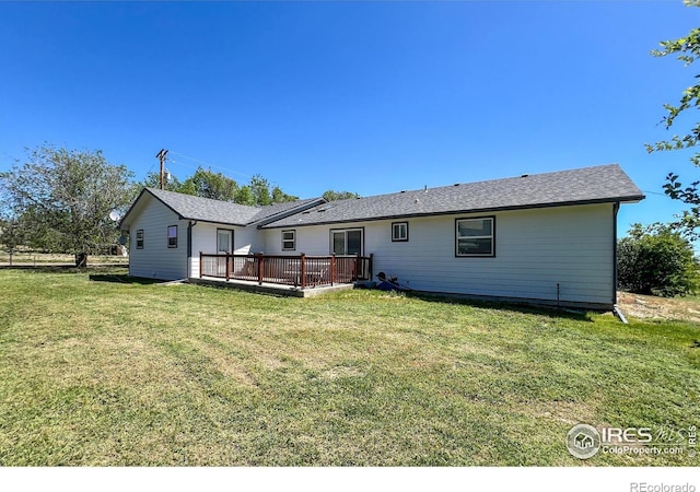 10007 E County Line Rd, Longmont, CO 80501 - back of property featuring a wooden deck and a lawn