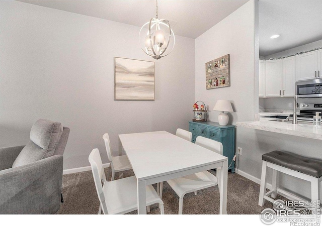 dining area with dark carpet, a chandelier, and baseboards