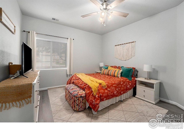 bedroom featuring baseboards, a ceiling fan, and light wood-type flooring