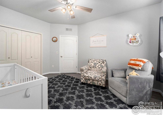 carpeted bedroom with baseboards, a closet, and a ceiling fan