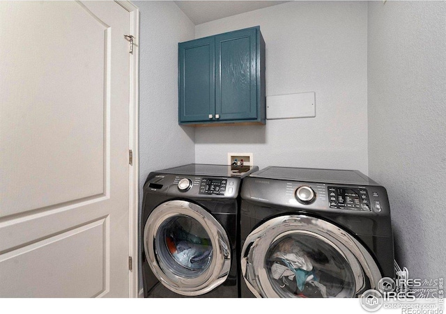 laundry room with washing machine and dryer and cabinet space