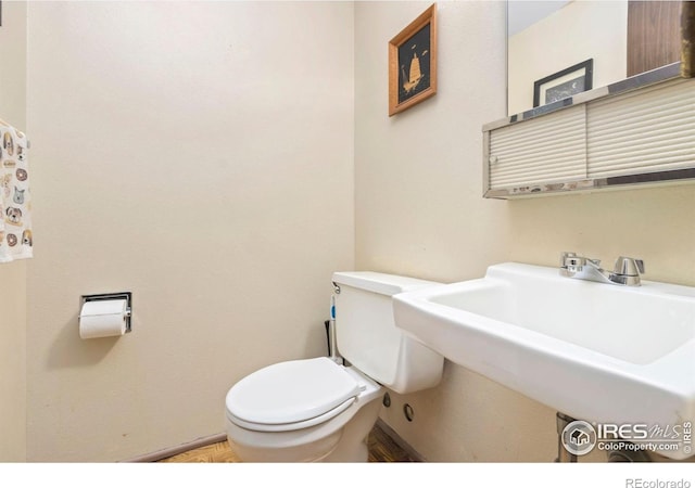2709 Harvard St Unit 3, Fort Collins, CO 80525 - bathroom with toilet, a sink, and baseboards