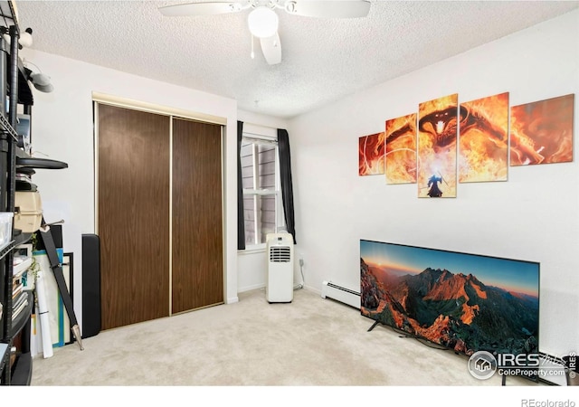 2709 Harvard St Unit 3, Fort Collins, CO 80525 - carpeted bedroom featuring a baseboard heating unit, a textured ceiling, a ceiling fan, and a closet