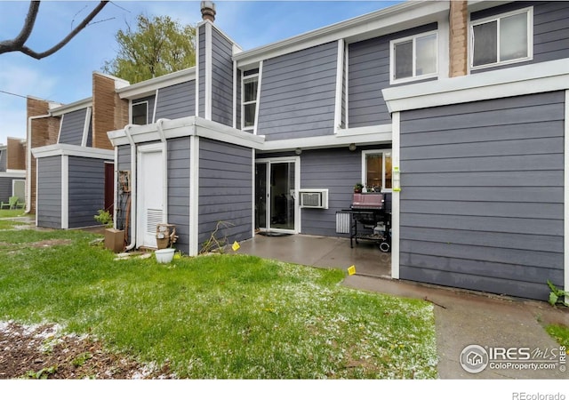 2709 Harvard St Unit 3, Fort Collins, CO 80525 - rear view of property featuring a patio area, a chimney, and a yard