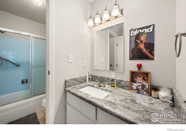 809 E Drake Rd Unit 107, Fort Collins, CO 80525 - full bath featuring toilet, vanity, combined bath / shower with glass door, and tile patterned floors
