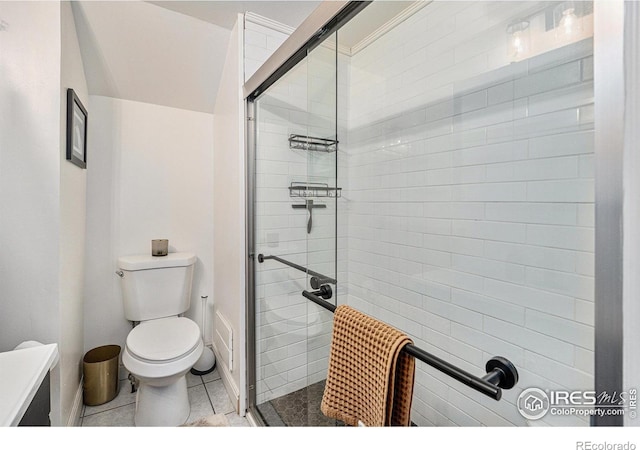 full bath featuring a shower stall, toilet, and tile patterned floors