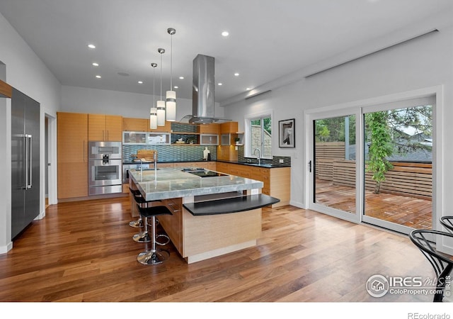 kitchen with island range hood, a sink, double oven, light wood-style floors, and open shelves