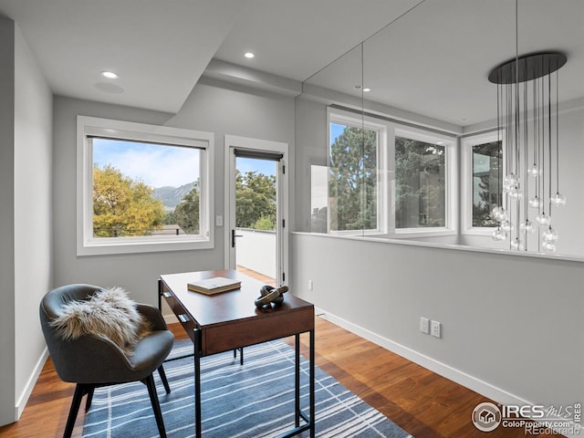 office space with plenty of natural light, wood finished floors, baseboards, and recessed lighting