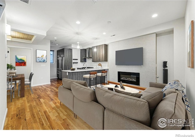 2625 W 25th Ave Unit 7, Denver, CO 80211 - living area with light wood-type flooring, recessed lighting, baseboards, and a large fireplace
