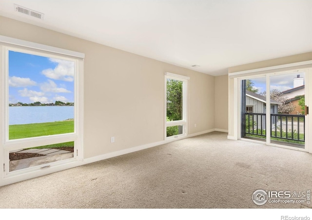 10481 Oxford Rd, Longmont, CO 80504 - carpeted spare room featuring a water view, baseboards, and plenty of natural light