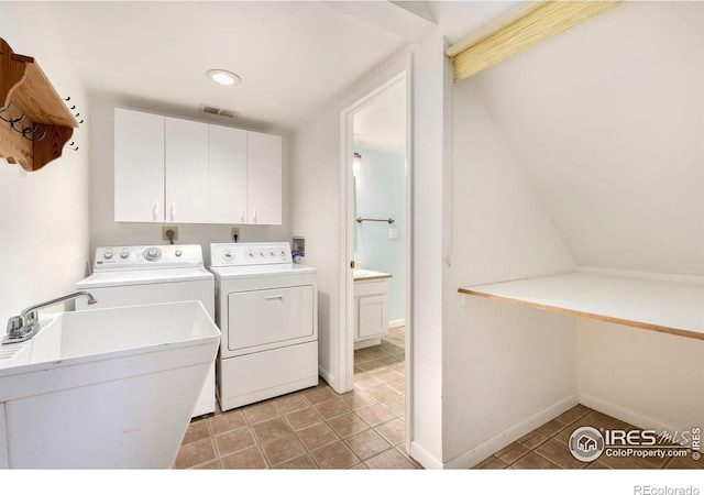 10481 Oxford Rd, Longmont, CO 80504 - laundry area with cabinet space, washing machine and dryer, light tile patterned flooring, and baseboards