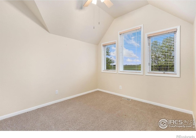 10481 Oxford Rd, Longmont, CO 80504 - unfurnished room with carpet flooring, ceiling fan, vaulted ceiling, healthy amount of natural light, and baseboards