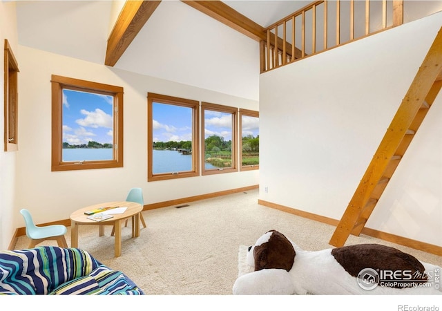 10481 Oxford Rd, Longmont, CO 80504 - carpeted living room featuring baseboards, beamed ceiling, high vaulted ceiling, and a water view