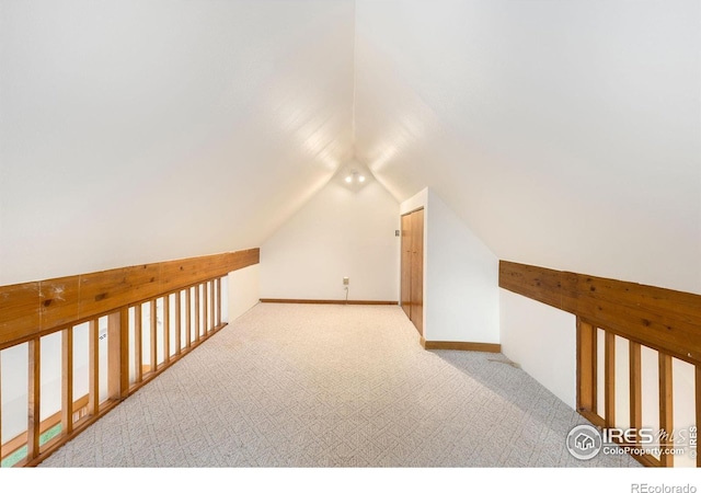 10481 Oxford Rd, Longmont, CO 80504 - additional living space with carpet floors, vaulted ceiling, and baseboards