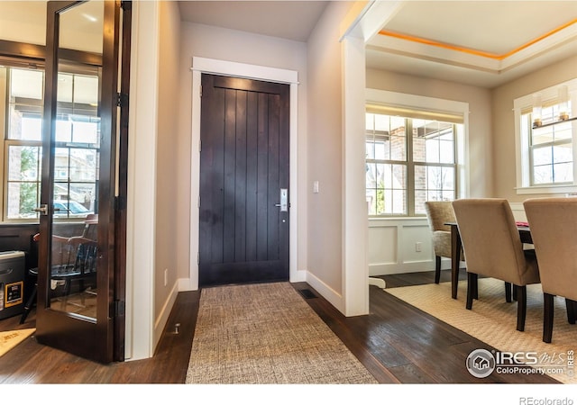 1152 S Ogden St, Denver, CO 80210 - foyer featuring dark wood finished floors, healthy amount of natural light, and baseboards