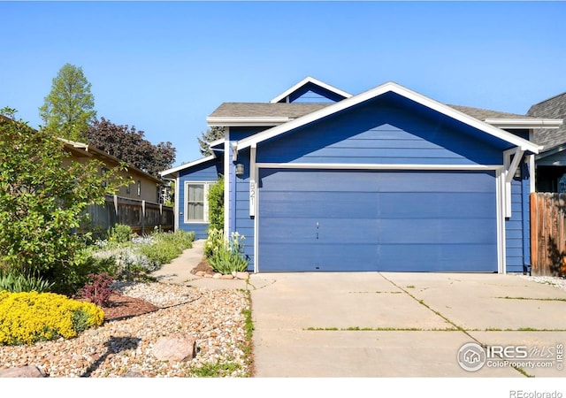821 Hayden Ct, Longmont, CO 80503 - view of front facade with a garage, fence, and driveway