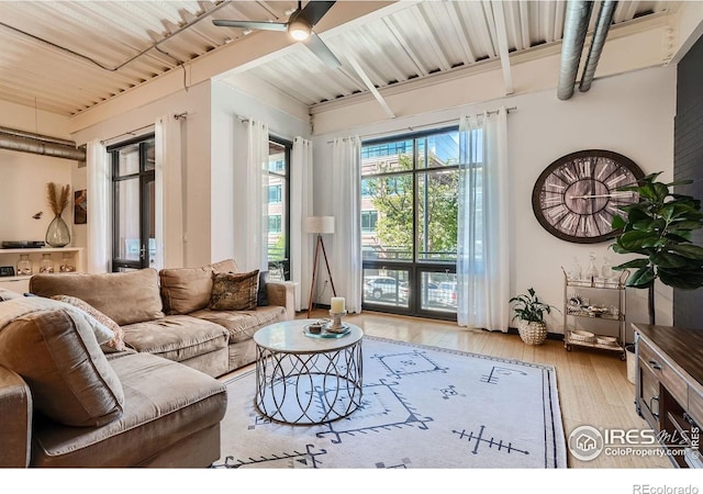 living room featuring hardwood / wood-style floors, ceiling fan, and french doors