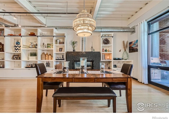 1360 Walnut St Unit 202, Boulder, CO 80302 - dining space featuring light wood finished floors, a chandelier, and beamed ceiling