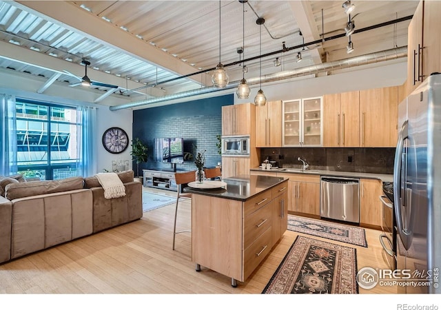 1360 Walnut St Unit 202, Boulder, CO 80302 - kitchen featuring appliances with stainless steel finishes, light brown cabinets, open floor plan, light wood finished floors, and a breakfast bar area