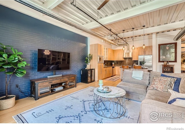 1360 Walnut St Unit 202, Boulder, CO 80302 - living room with light wood finished floors and brick wall