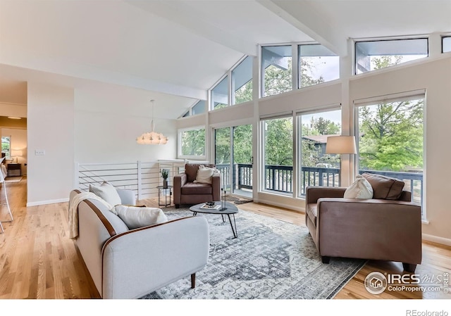 3410 Heidelberg Dr, Boulder, CO 80305 - living area with beamed ceiling, high vaulted ceiling, light wood finished floors, a chandelier, and baseboards