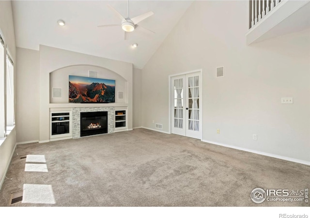 3227 Honeysuckle Ct, Fort Collins, CO 80521 - unfurnished living room featuring ceiling fan, carpet flooring, a glass covered fireplace, high vaulted ceiling, and baseboards