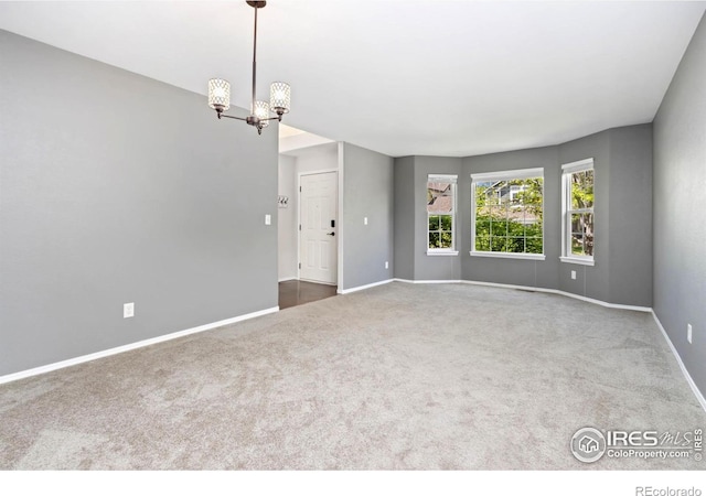 3227 Honeysuckle Ct, Fort Collins, CO 80521 - spare room with carpet flooring, a chandelier, and baseboards