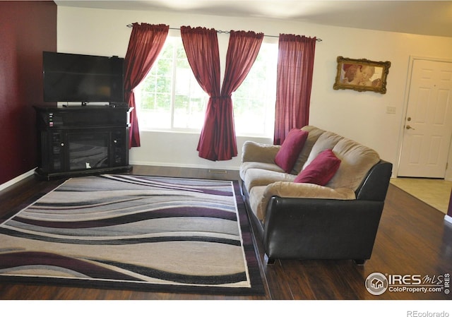 living area with wood finished floors and baseboards